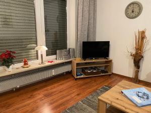 a living room with a television and a window at Apartment Panorama in Sonthofen