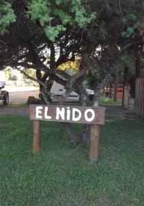 a sign that says el huboco in front of a tree at El Nido in Sauce Viejo