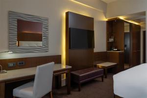 a hotel room with a desk and a television at Radisson Blu Hotel, Addis Ababa in Addis Ababa
