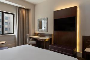 a hotel room with a bed and a desk at Radisson Blu Hotel, Addis Ababa in Addis Ababa