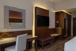a hotel room with a desk and a television at Radisson Blu Hotel, Addis Ababa in Addis Ababa +190 photos