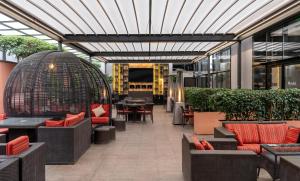 an outdoor patio with tables and chairs and a building at Radisson Blu Hotel, Addis Ababa in Addis Ababa