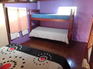 a small room with two bunk beds and a mattress at El Nido in Sauce Viejo