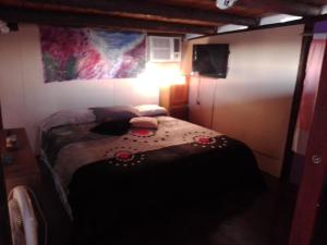 a bedroom with a bed with flowers on it at El Nido in Sauce Viejo