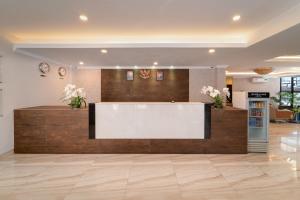 a lobby with a reception desk in a building at Barelang Hotel Nagoya Batam in Nagoya
