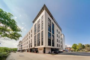a large white building sitting on the side of a street at Barelang Hotel Nagoya Batam in Nagoya