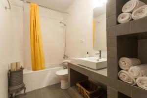 a bathroom with a sink and a toilet and a tub at Can Pitu in Alfondeguilla +29 photos