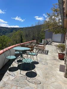 a table and chairs on a patio with a view at Total Peace and quiet on the top of the mountain, in Prats-de-Mollo-la-Preste +25 photos