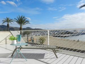 a balcony with a table and a view of a boat at Harmony Seafront 365 by Can Ventet in Port de Pollensa