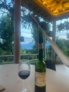 AngelópolisCasa de Campo Cerca a Medellín的桌上的一瓶酒和一杯酒