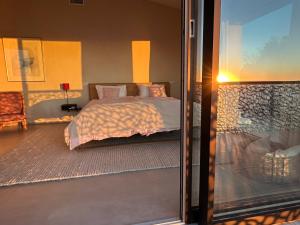 a bedroom with a bed and a sliding glass door at Luxury Villa with unmatched view and Sea-Fall Pool in Costa Paradiso +61 photos