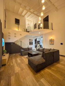 a large living room with a couch and a tv at The Castle By Scenic Weligama in Weligama