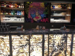 a bar with a painting on the wall at Hotel Zaniah in Huancayo