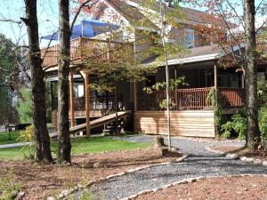 a house with a large deck with trees at Gite Passion et Tendresse B&B in Shefford +66 photos