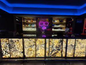 a bar with a mask and purple glasses at Hotel Zaniah in Huancayo +10 photos