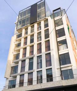 a tall white building with a lot of windows at Hotel Zaniah in Huancayo