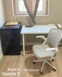 a white desk with a white chair in a room with a window at We Host Costa da Caparica in Costa da Caparica +24 photos