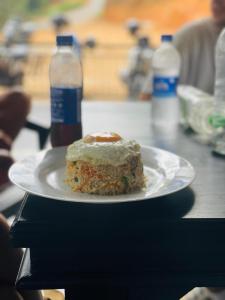 a plate of food on a table with two bottles of water at Sinharaja Eliphinity Hotel and Restaurant in Nikawatawana +24 photos