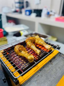 three pieces of food cooking on a grill at Sinharaja Eliphinity Hotel and Restaurant in Nikawatawana