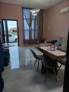 a living room with a table and chairs and a couch at Casa com piscina aquecida e área de festas no litoral in Ilhota