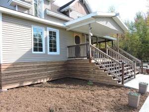 a front porch of a house with a wooden deck at Gite Passion et Tendresse B&B in Shefford