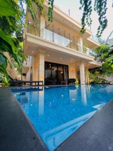 a swimming pool in front of a house at The Castle By Scenic Weligama in Weligama