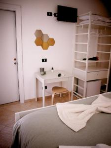 a bedroom with a bed and a desk and a ladder at MariMare B&B in Pozzallo +9 photos