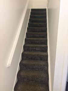 a flight of stairs in a house at Goodness homes in Manchester