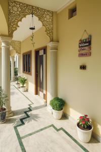 an empty hallway with potted plants in a building at Hidden Leaf in Dehradun +20 photos