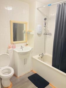 a bathroom with a toilet and a sink and a shower at Goodness homes in Manchester