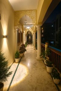 a hallway of a building with potted plants at Hidden Leaf in Dehradun
