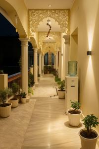 a hallway of a building with potted plants at Hidden Leaf in Dehradun