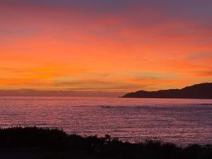 a sunset over a large body of water at Charmant Studio dans dépendance face à la mer in Serra-di-Ferro +2 photos