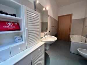 a bathroom with a sink and a toilet and a tub at Kibilù - Cozy Studio few steps from Duomo City Centre in Milan
