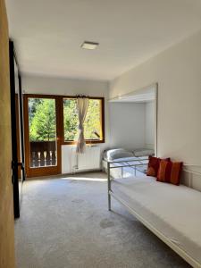 a bedroom with a bed and a large window at Cozy Mountain Stay near Kranjska Gora in Gozd Martuljek