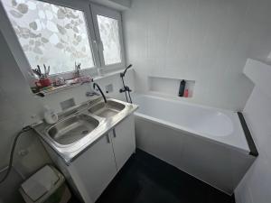 a small bathroom with a sink and a window at Apartament 3 in Biała Podlaska +1 photo