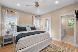 a bedroom with a large bed and windows at 240 Olive Shell Court in Hilton Head Island +45 photos