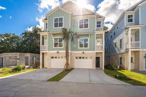 a large house with a palm tree in front of it at 240 Olive Shell Court in Hilton Head Island