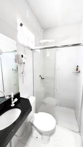 a bathroom with a shower and a toilet and a sink at Arejar Hotel in Juruti