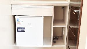 a small cabinet with a desk and a refrigerator at Arejar Hotel in Juruti +14 photos