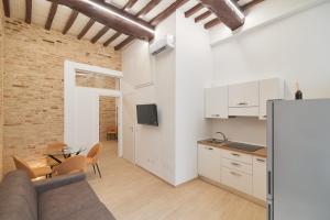 a kitchen and living room with a couch and a table at AM10 - Modern flat in historic center in Perugia