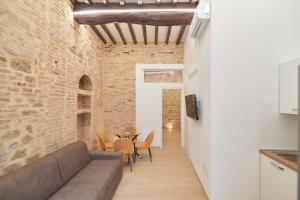 a living room with a couch and a table at AM10 - Modern flat in historic center in Perugia