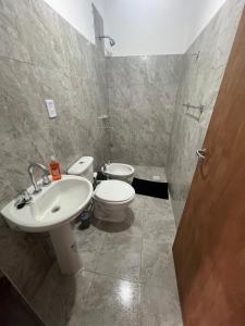 a bathroom with a sink and a toilet at Nexo departamentos in San José