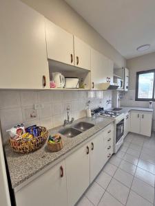 a kitchen with a sink and a counter top at Departamento Bloom in Bahía Blanca