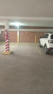 a parking garage with a car parked next to a pole at Departamento Bloom in Bahía Blanca