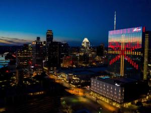 a city skyline at night with a lit up building at Fairmont Austin in Austin