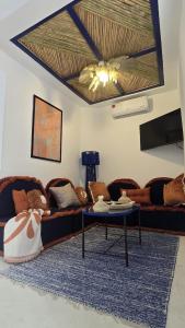a living room with a couch and a table at Riad Lyabaïana privatisé, piscine et vue mer dans la médina in Tangier +31 photos