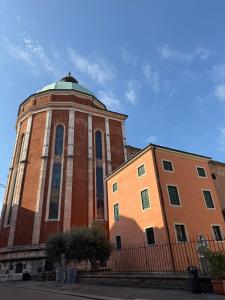 a large brick building with a dome on top of it at casa duomo vicenza in Vicenza
