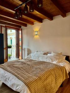 a large bed in a bedroom with wooden ceilings at casa duomo vicenza in Vicenza