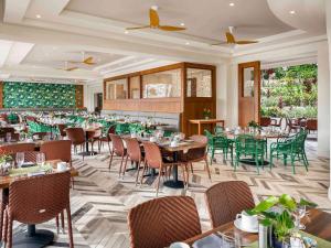 a restaurant with tables and chairs in a room at Fairmont Kea Lani, Maui in Wailea